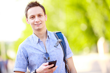 Image showing Close up portrait of a young man with phone