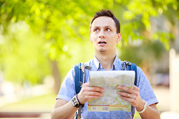 Image showing Young man with a map outdoors