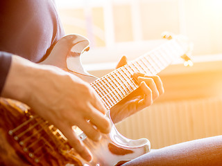 Image showing Male hand playing on acoustic guitar. Close-up.