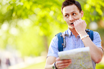 Image showing Young man with a map outdoors