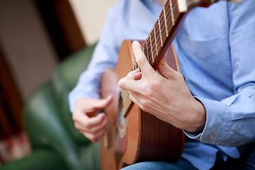 Image showing Man playing classic, acoustic guitar