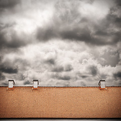 Image showing stormy sky and tiled roof top