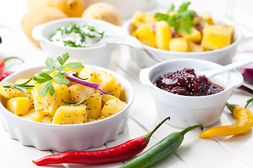 Image showing Baked potatoes with chutney and sour cream