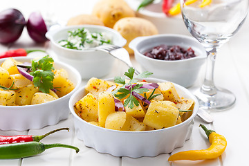 Image showing Baked potatoes with chutney and sour cream