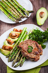 Image showing Glazed green asparagus with grilled pork chop