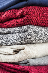 Image showing Stack of handmade wool sweaters