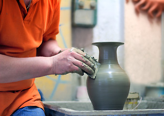 Image showing People at work: the production of ceramic vases on a Potter\'s wh