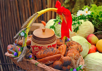 Image showing Basket of bread, decorated with ribbons, and vegetables