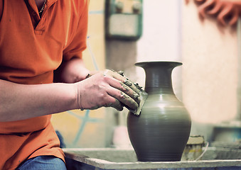 Image showing People at work: the production of ceramic vases on a Potter\'s wh