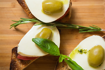 Image showing Bruschetta with tomato, mozarella and olive