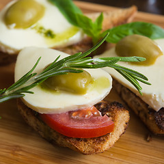 Image showing Bruschetta with tomato, mozarella and olive