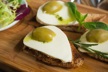 Image showing Bruschetta with tomato, mozarella and olive