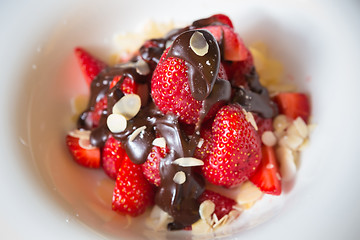 Image showing fresh strawberries dipped in dark chocolate