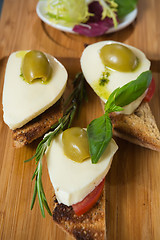 Image showing Bruschetta with tomato, mozarella and olive