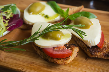 Image showing Bruschetta with tomato, mozarella and olive