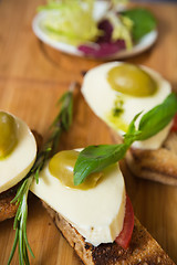 Image showing Bruschetta with tomato, mozarella and olive