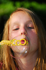 Image showing Young girl soap bubbles