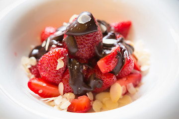 Image showing fresh strawberries dipped in dark chocolate
