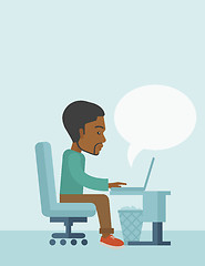 Image showing African siiting infront his computer.