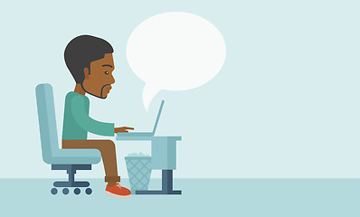 Image showing African sitting infront his computer.