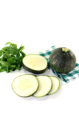 Image showing rotund raw zucchini on a checkered napkin