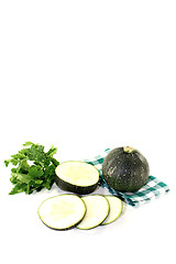 Image showing rotund raw zucchini on a green napkin