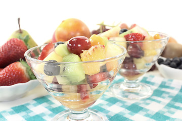 Image showing Fruit salad in a bowl on checkered napkin