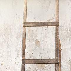 Image showing weathered stucco wall with wooden ladder