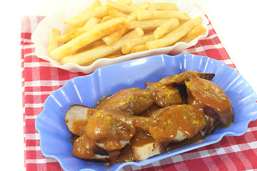 Image showing Currywurst with french fries
