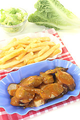 Image showing Currywurst with french fries with salad