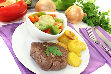 Image showing Ostrich steaks with baked potatoes