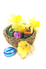 Image showing Easter Basket with chick, daffodils and colorful eggs