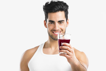 Image showing Athletic man drinking a juice