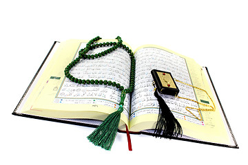 Image showing whipped Quran with rosary