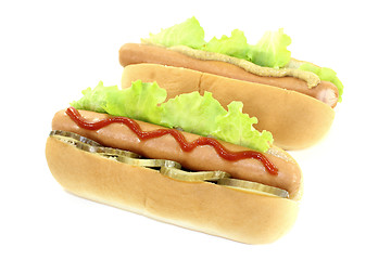 Image showing Hot dog with pickle, mustard and ketchup