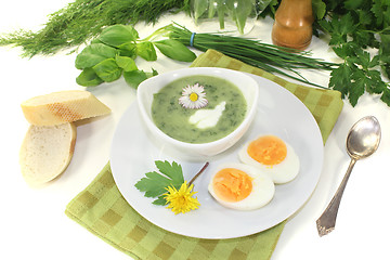 Image showing fresh herbs soup with a dollop of cream