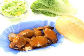 Image showing Currywurst with lettuce