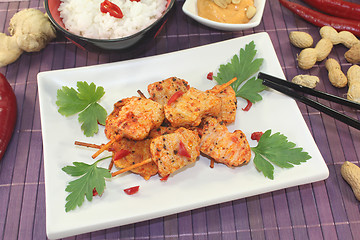 Image showing Asian satay skewers with chilli and rice