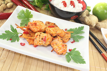 Image showing Asian satay skewers with chilli and parsley