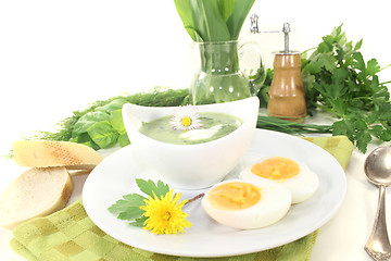 Image showing green herb soup with daisy