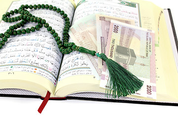 Image showing whipped Quran with Iranian Rials