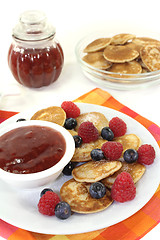 Image showing Poffertjes with berries and jelly