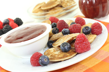 Image showing Poffertjes with berries and icing sugar