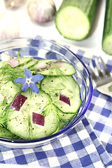 Image showing Cucumber salad with onions and borage flower