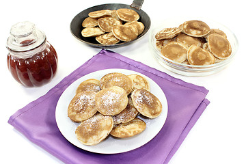 Image showing Poffertjes with powdered sugar and fruit jelly