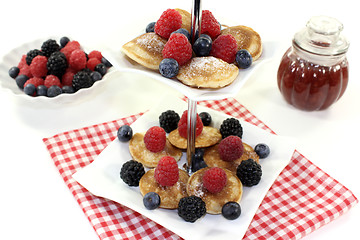 Image showing Poffertjes with berries on a cake stand