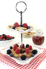 Image showing Poffertjes with blackberries on a cake stand