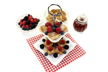 Image showing Poffertjes with raspberries on a cake stand
