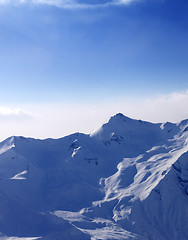 Image showing Snowy mountains in mist at early morning