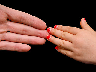 Image showing Big hand palm meeting small girl hand with cracked pink nail pai